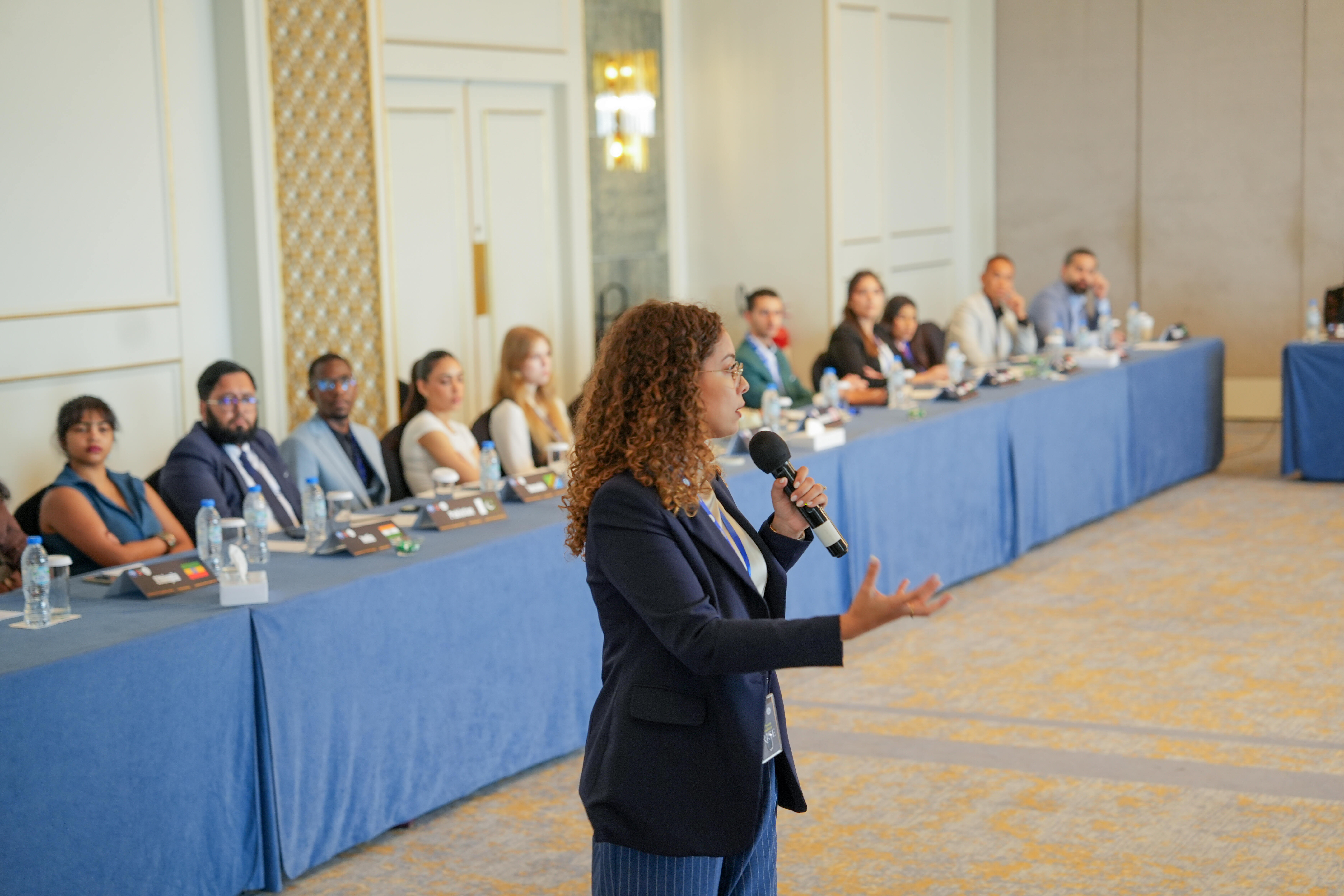 Summit Speaker with participants in the background