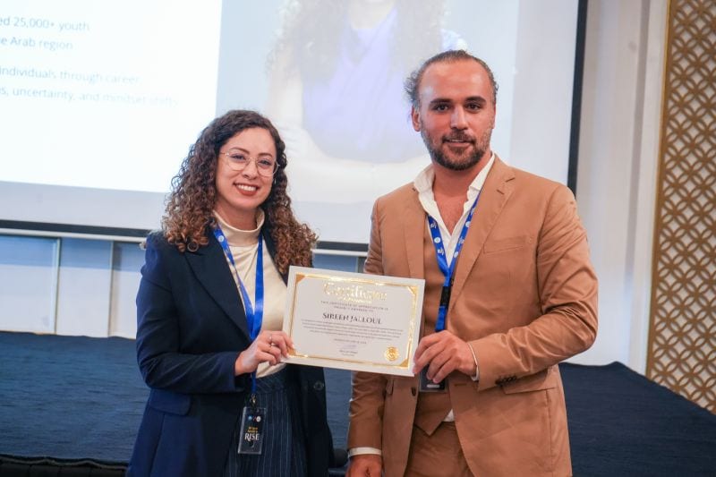 A delegate receiving a certificate at the Future Youth Leadership Summit.