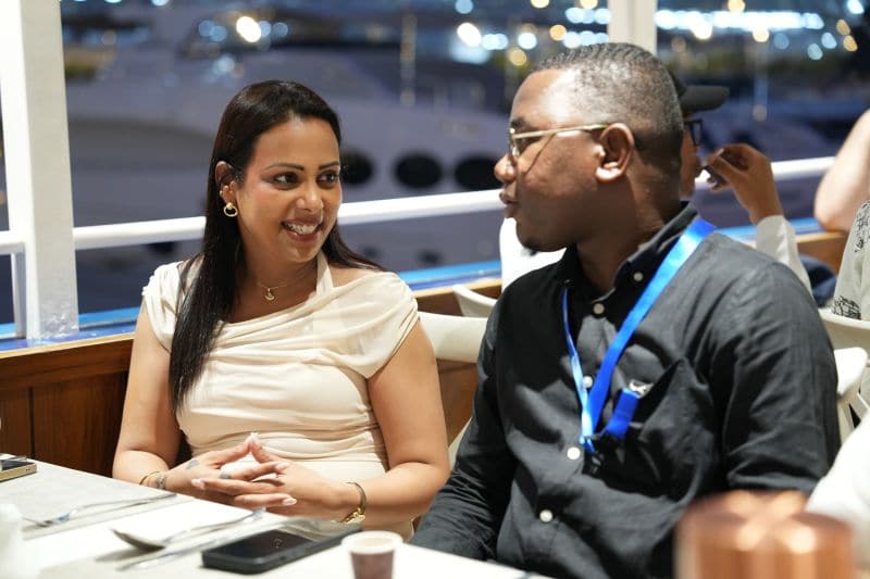 Two delegates in conversation during a session at the summit.