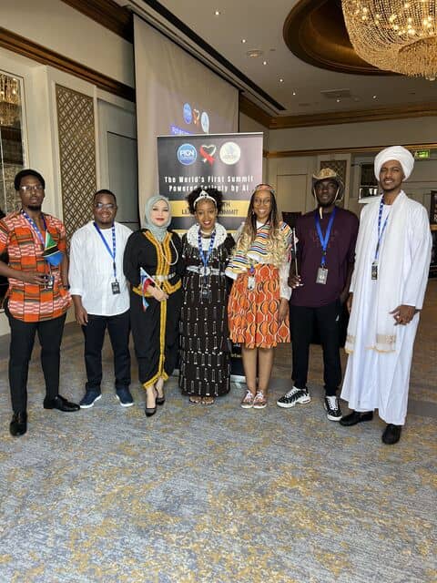 Delegates in national dress standing together at the Future Youth Leadership Summit.