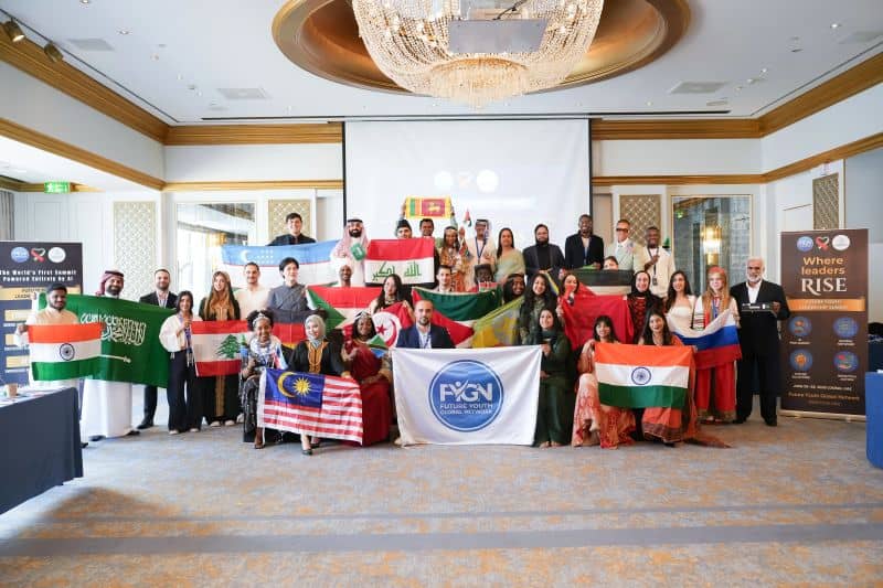 Delegates holding national flags in the summit hall in Dubai.