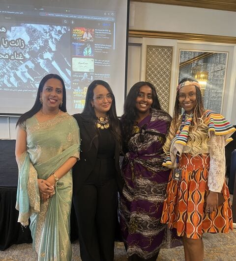 Four delegates in national dress at the Future Youth Leadership Summit.