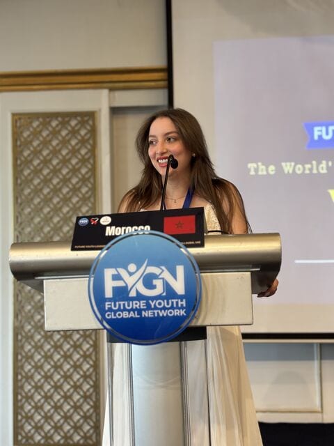 A delegate speaking from the summit podium behind a name card reading Morocco.